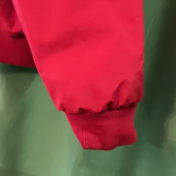 Bright red windbreaker with navy blue fleece lining and insulated sleeves. - Picture 8 of 11